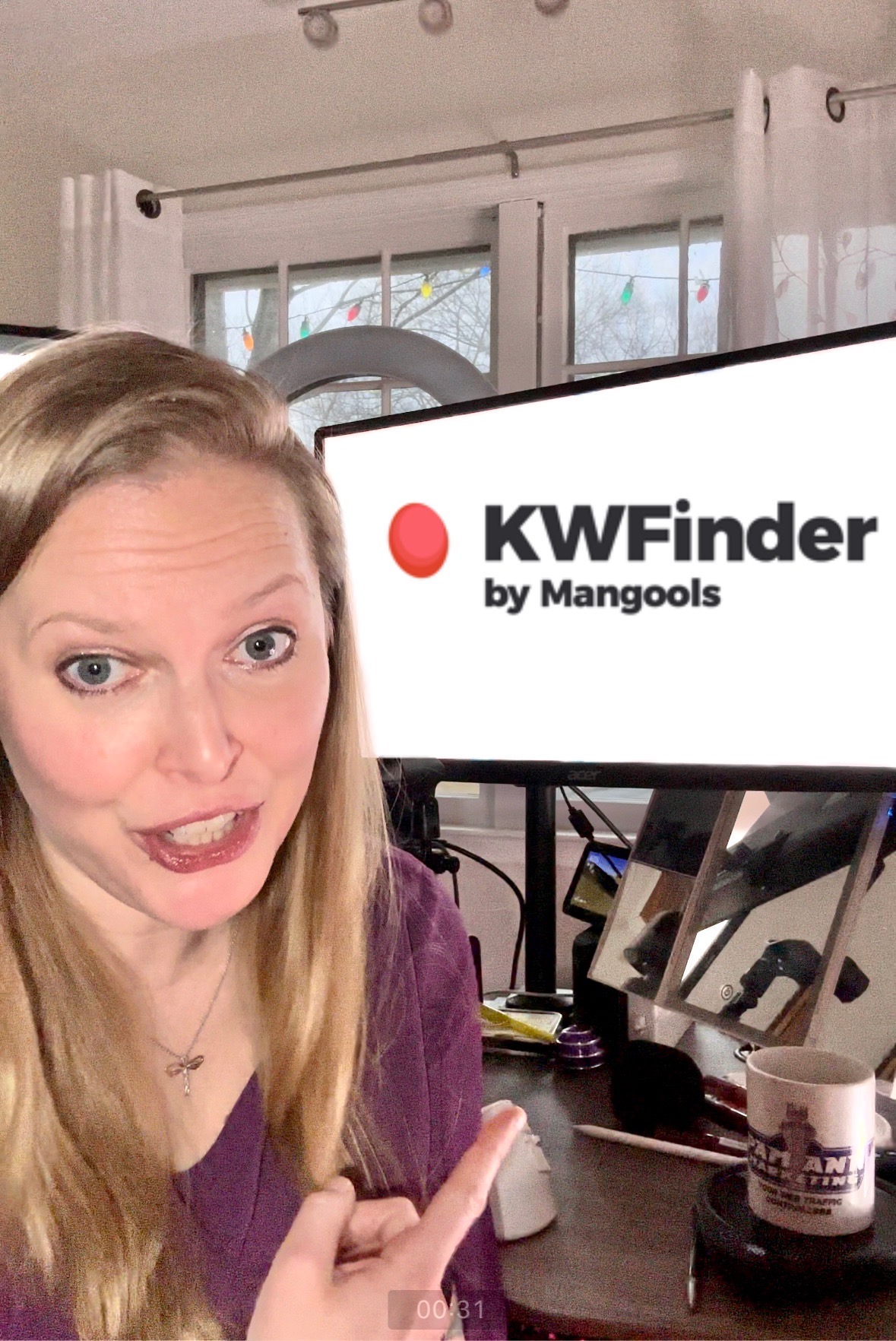 Picture of Pam pointing at computer screen with the KWFinder logo on it